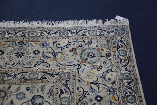 A Tabriz cream ground carpet, 12ft 6in. by 9ft 9in.